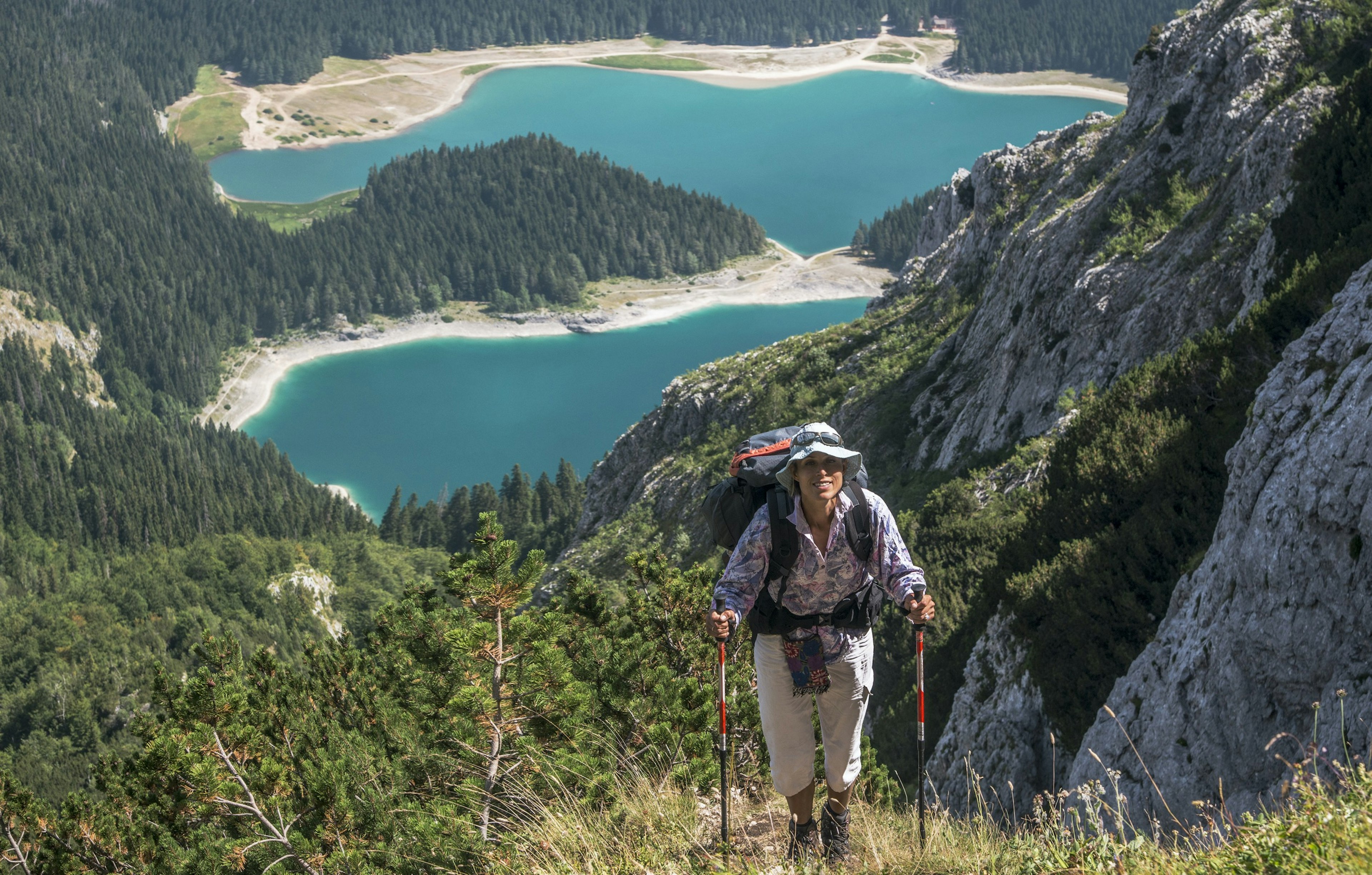 Scene in Durmitor mountains (Montenegro). Woman with backpack against Black Lake background.; Shutterstock ID 791462698; your: Ben N Buckner; gl: 65050; netsuite: Client Services; full: Montenegro