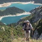 Scene in Durmitor mountains (Montenegro). Woman with backpack against Black Lake background.; Shutterstock ID 791462698; your: Ben N Buckner; gl: 65050; netsuite: Client Services; full: Montenegro