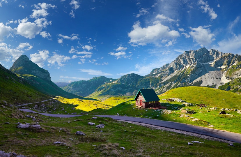 Amaizing sunset view on Durmitor mountains, National Park, Mediterranean, Montenegro, Balkans, Europe.  Bright summer view from Sedlo pass. Instagram picture. The road near the house in the mountains.; Shutterstock ID 1124590235; your: Ben N Buckner; gl: 65050; netsuite: Client Services; full: Montenegro