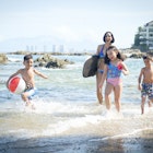Mexico, Puerto Vallarta, mother and three children having fun at seafront