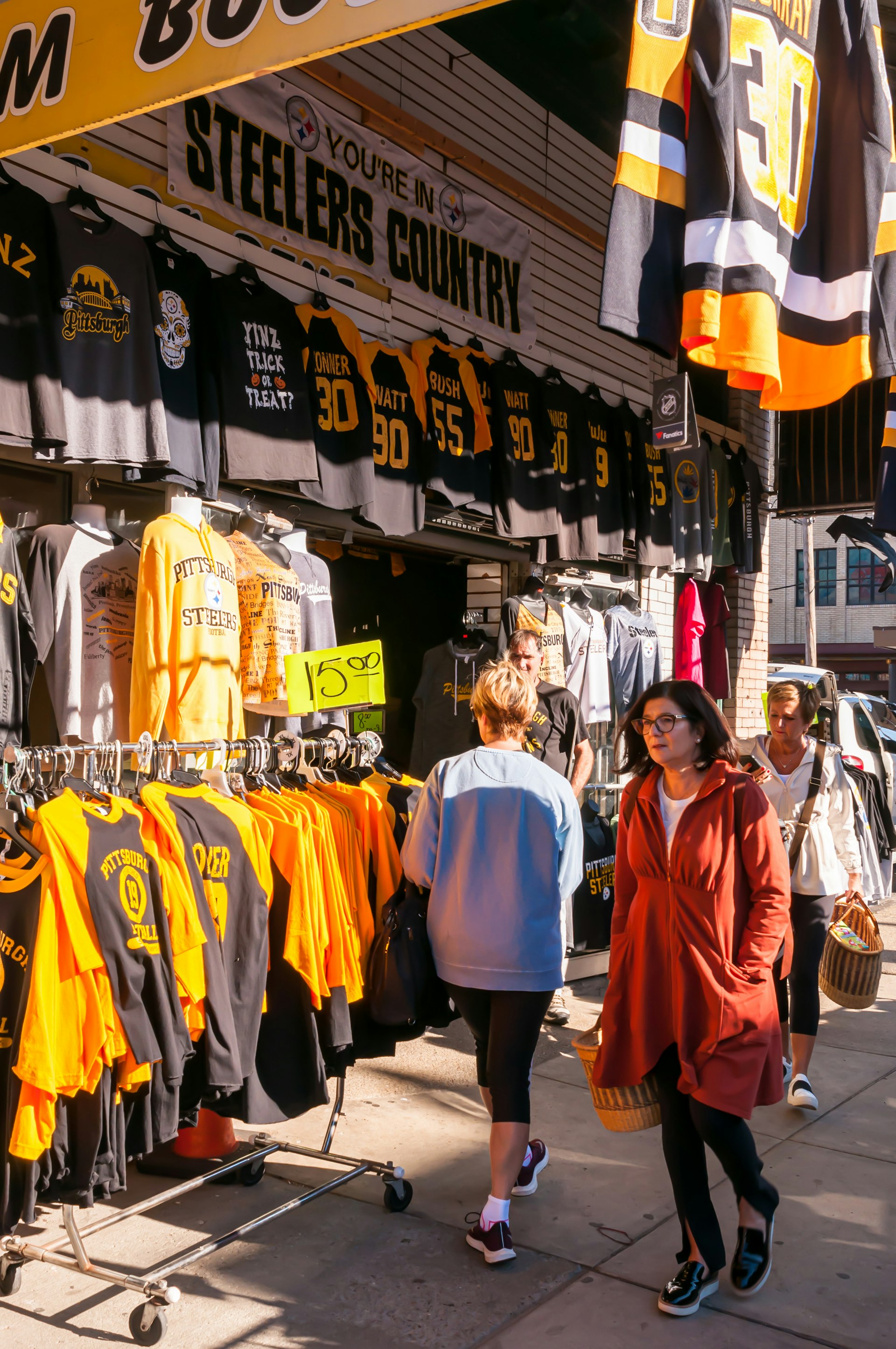 People in front of a store on Penn Avenue in the Strip District selling Pittsburgh related sports teams clothing and items