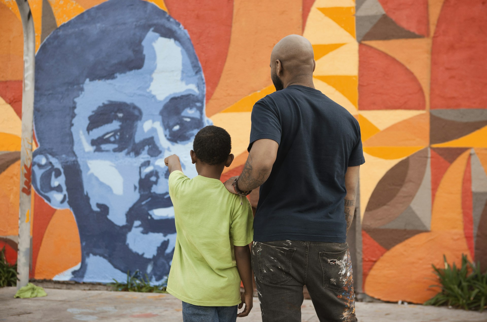 Father and son admiring mural