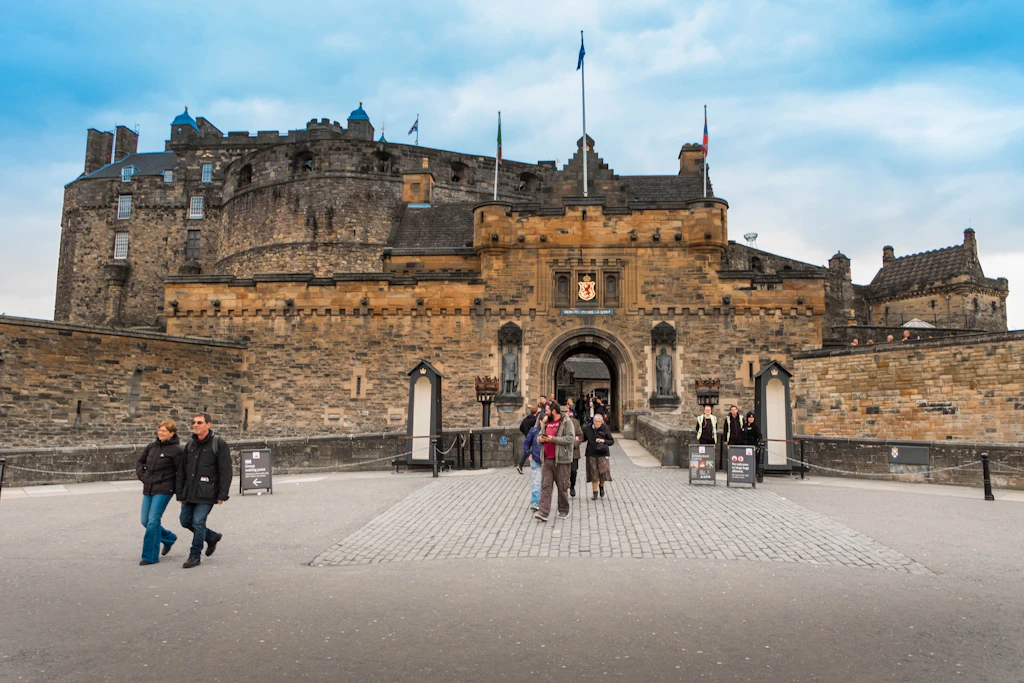 Visitors leaving through the main gate of a vast fortress