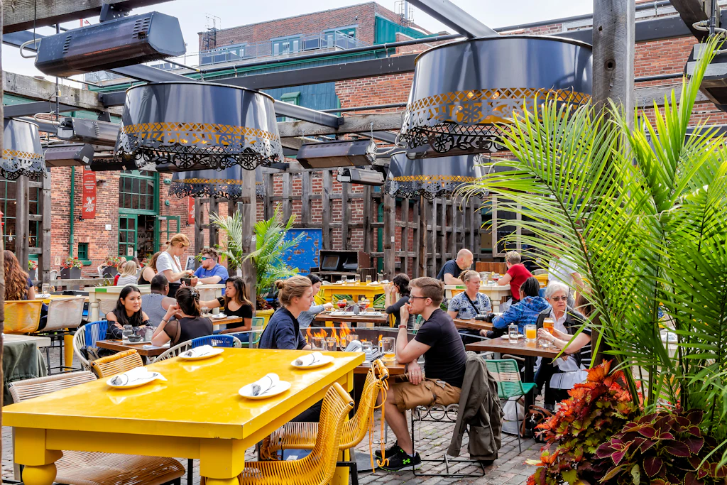 Visitors drinking at an outdoor bar in the Distillery District, Toronto