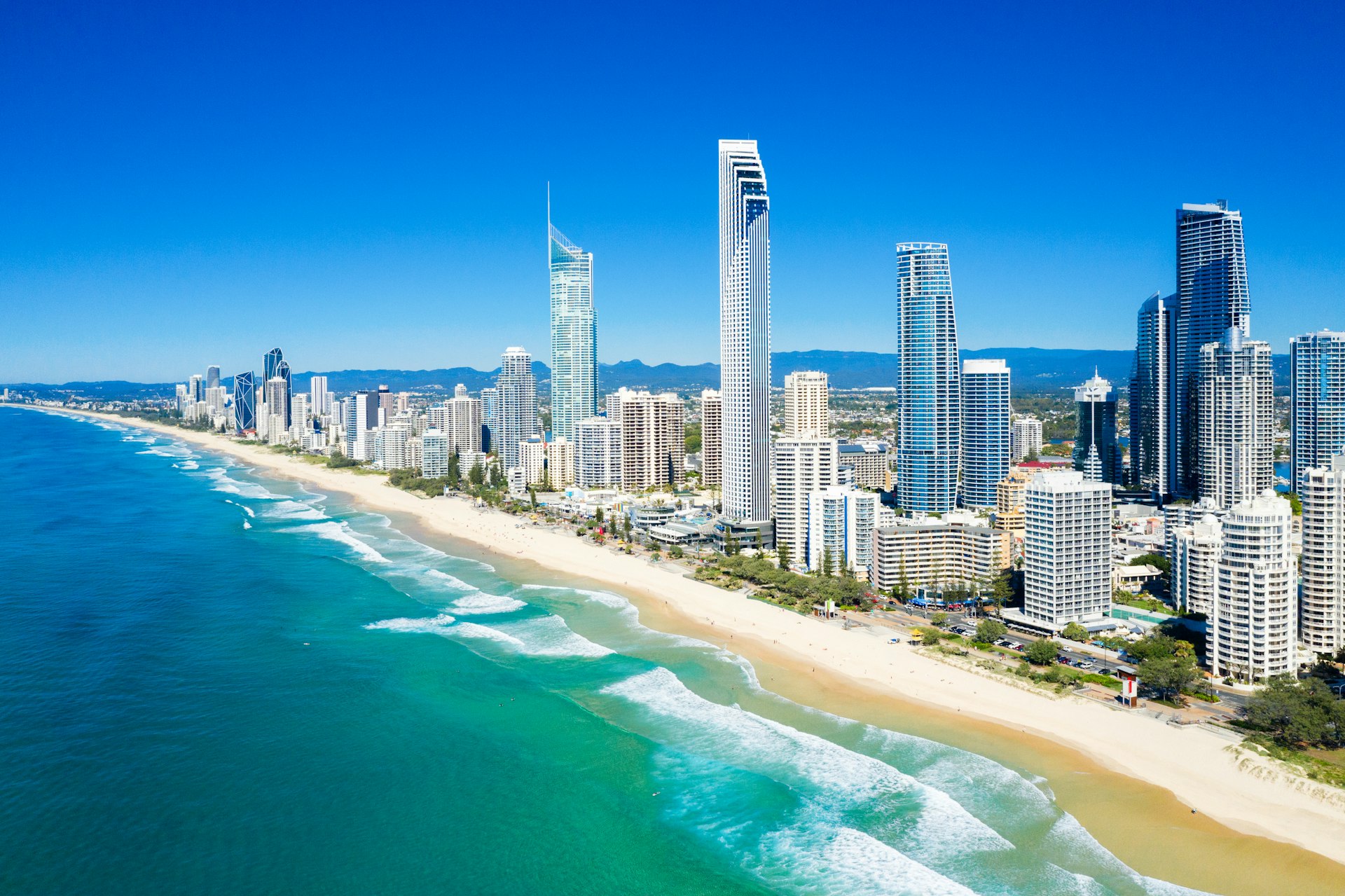 An aerial view of the sunny coast of surfers paradise with skyscrapers backing on to beaches