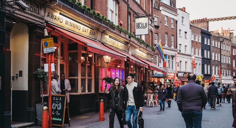 April 14, 2019: People walking past Ku Bar, one of the largest gay bars in London, located just off Leicester Square.