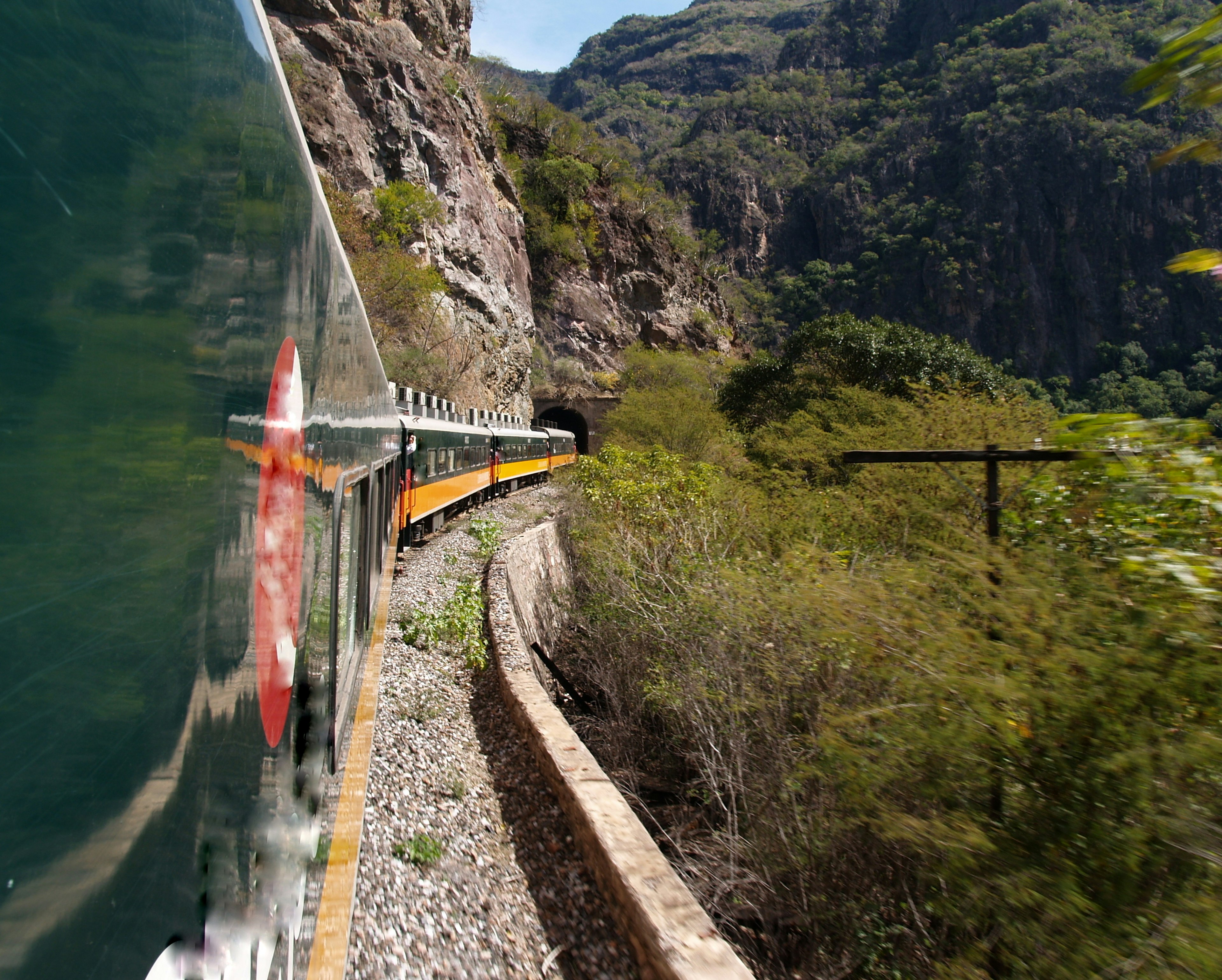 View of the side of train carriages winding their way along the Copper Canyon Railway