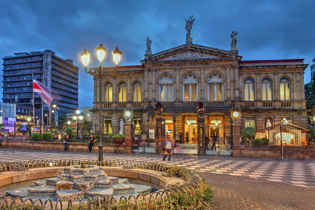 The outside of the Teatro Nacional lit up at night