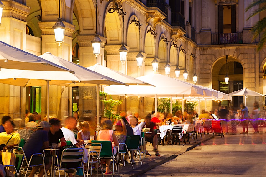 Outdoor restaurants at Placa Reial in night,