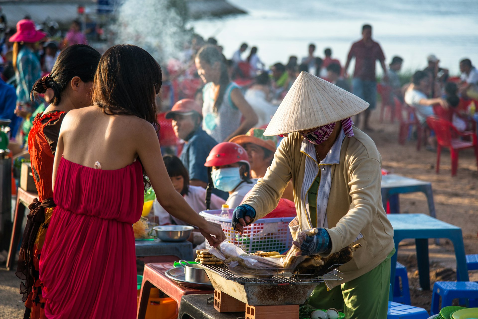 Local woman selling hot corn at the farmer market in Phu Quoc, Vietnam