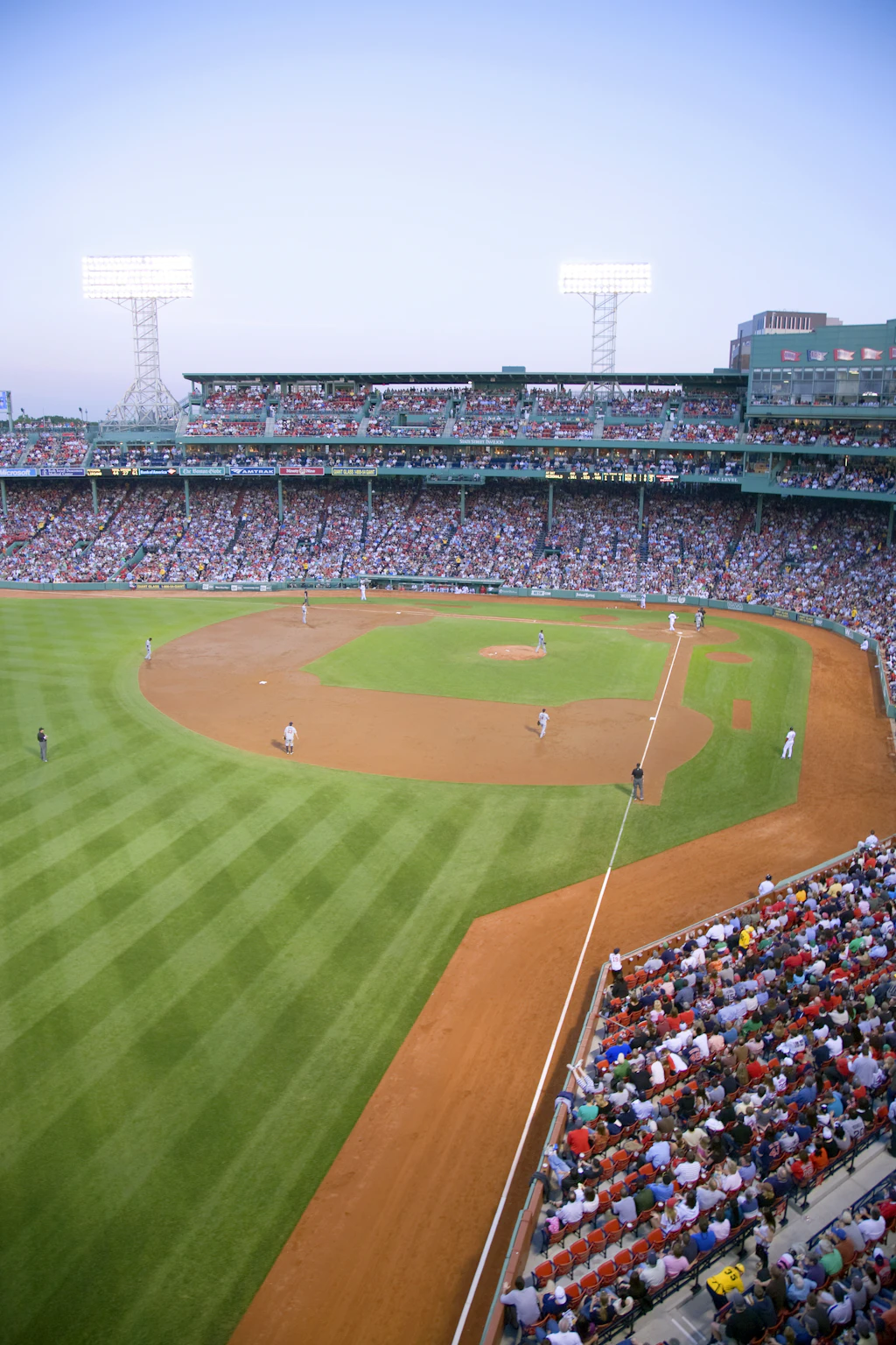 Fenway Park: Boston Red Sox vs Minnesota Twins A packed baseball stadium with fans sat in tiered seats watching the action on the pitch below