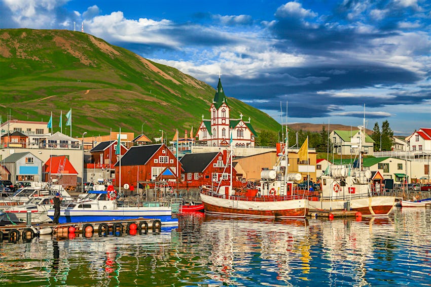 The harbour of the historic town of Husavik with fishing boats and colourful houses.''