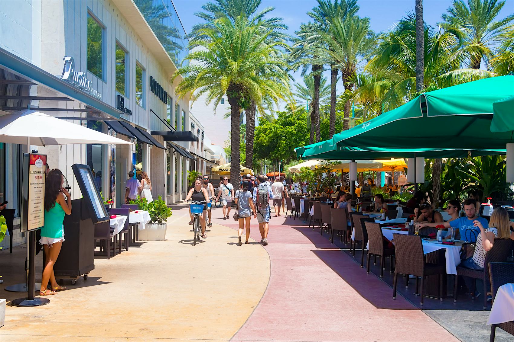 A pedestrianized street lined with restaurant tables''