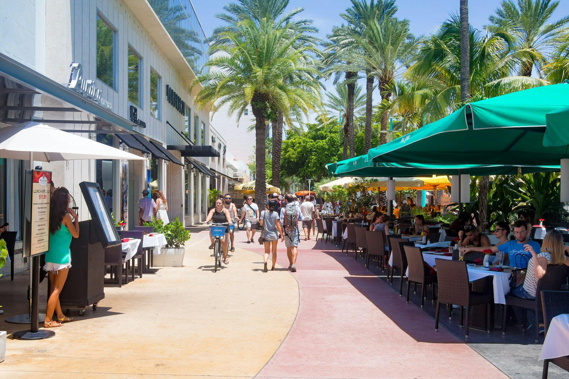 A pedestrianized street lined with restaurant tables
