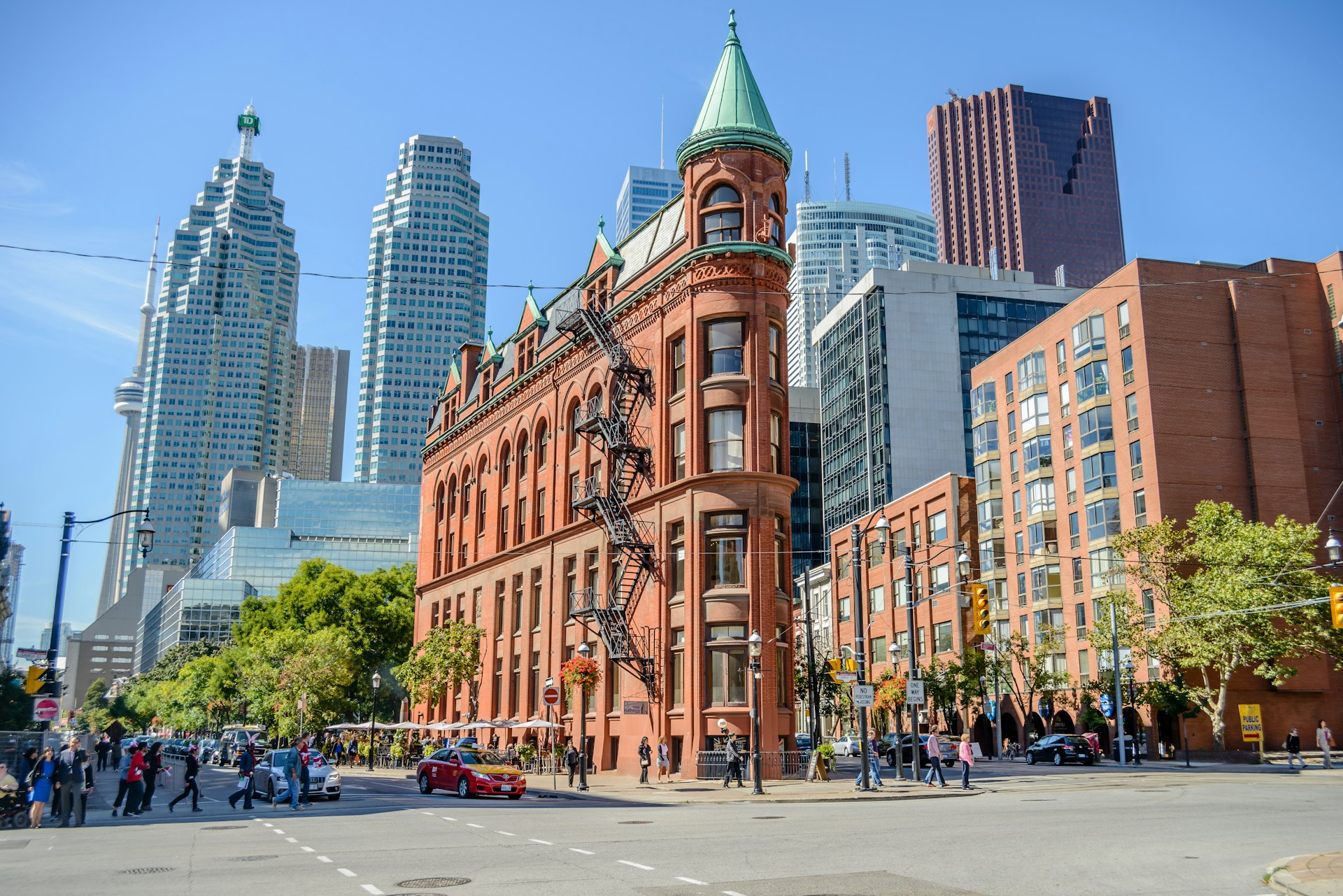 People walk in the Gooderham building area, a Victorian historic building surrounded by the financial district in Toronto,