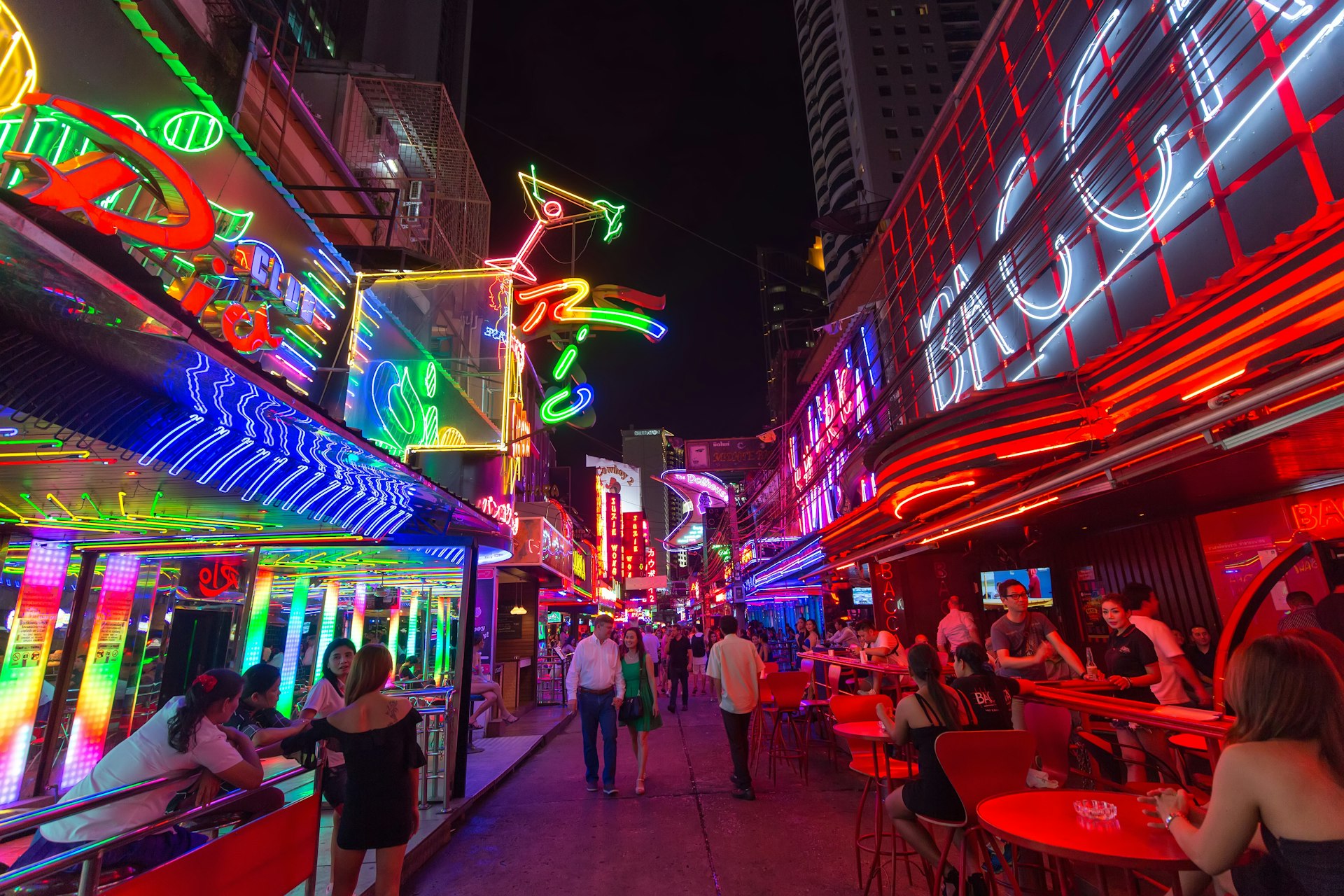 View of the colourful neon signs of Soi Cowboy street in the red-light district of Nana.