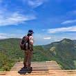 Man with hiking equipment walking in World's End within the Horton Plains National Park in Sri Lanka - success concept