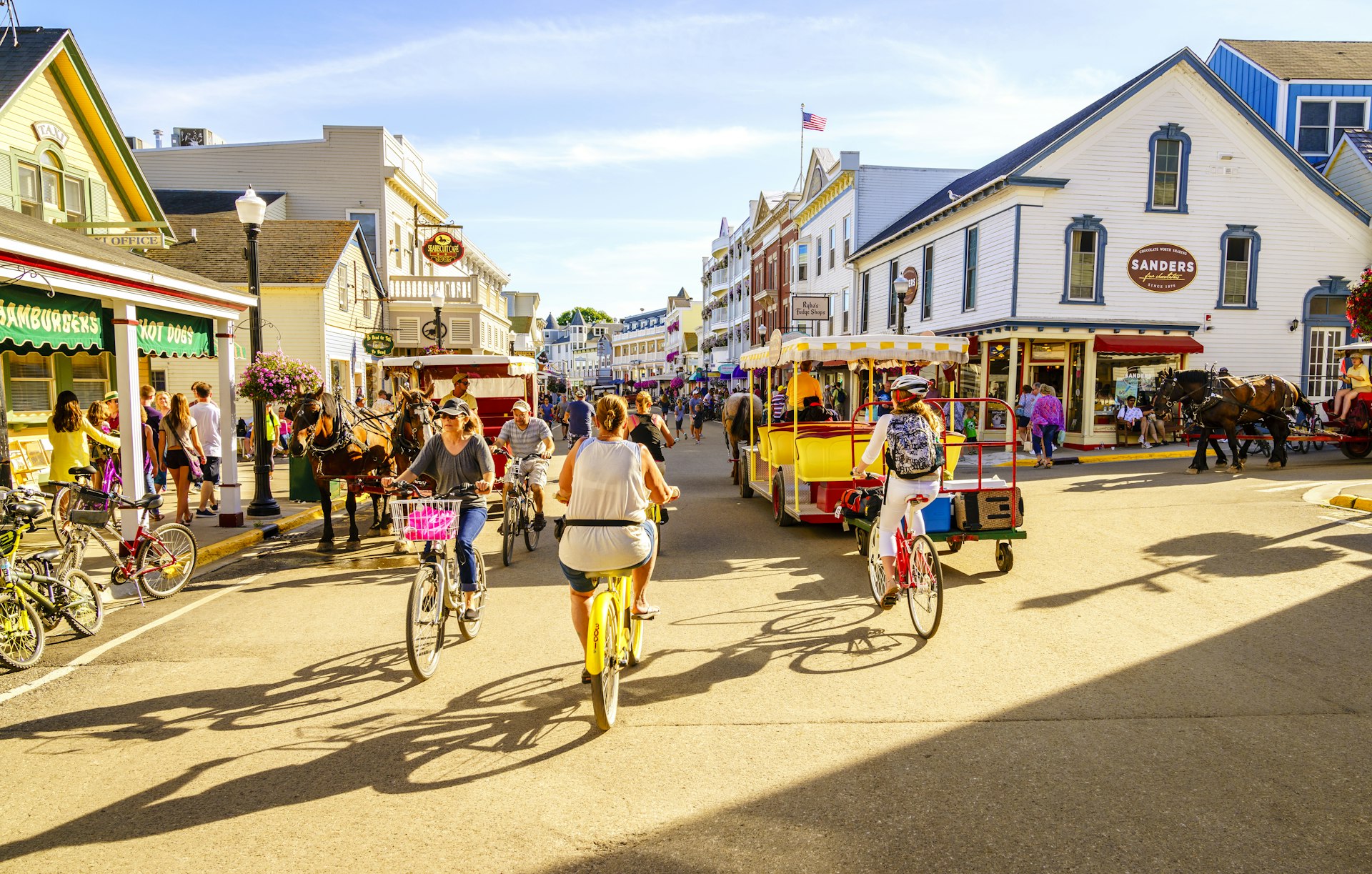 Visitors walk and ride bicycles on a street