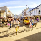 August 8, 2016: Visitors walk and ride at Market Street on Mackinac Island.