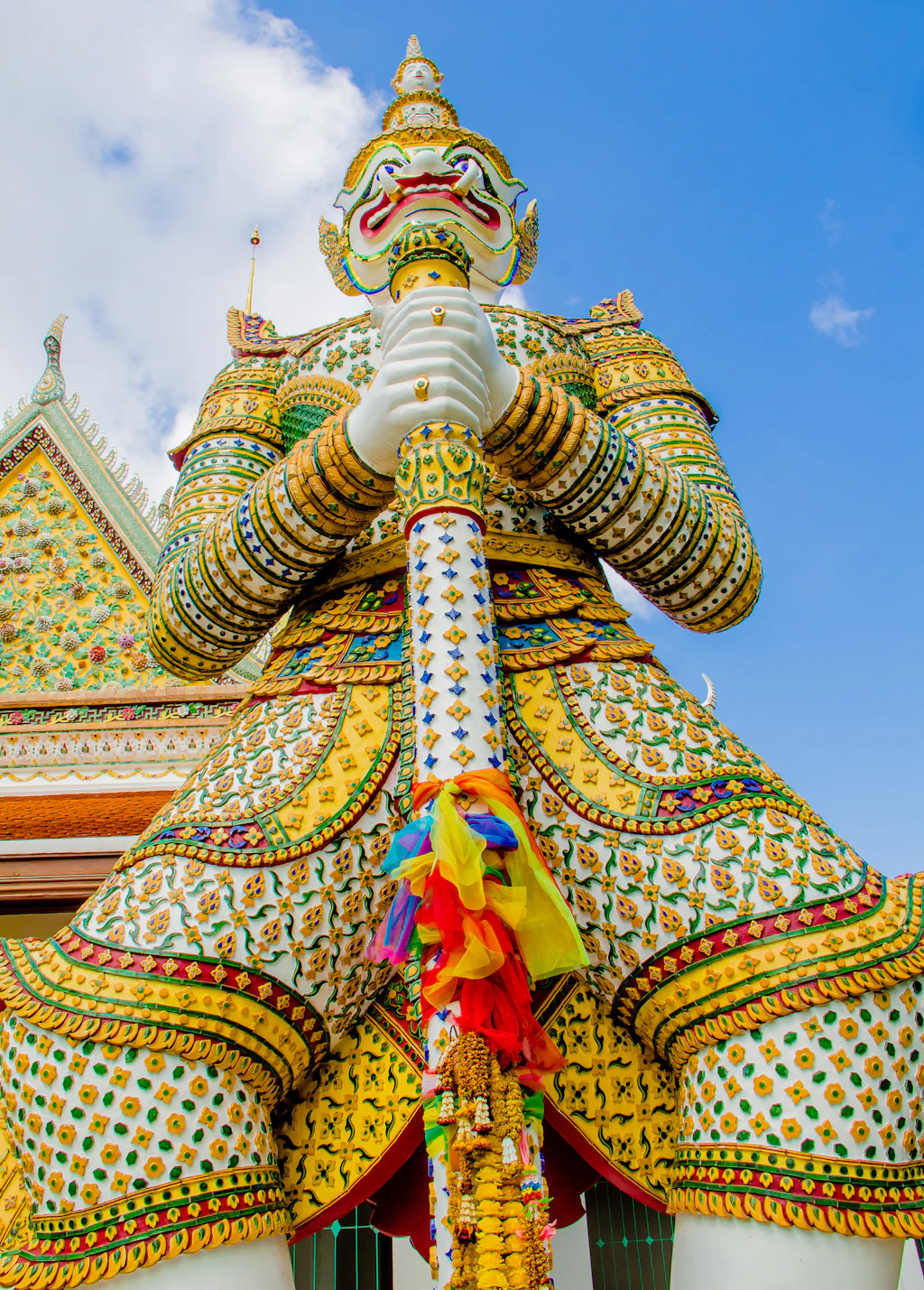 Grand Palace dvarapala A colorful dvarapala (gate guardian) statue at the Grand Palace in Bangkok with a fearsome face and Thai headdress holding a baton.