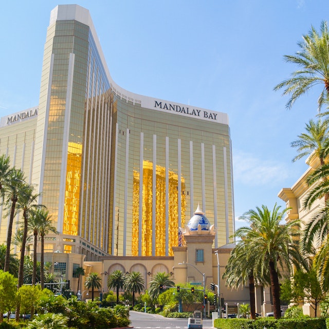 LAS VEGAS, USA AUGUST 14; Enormous Mandalay Bay Hotel Resort and Casino with beautifully landscaped entrance to modern architectural gold glass facade of building August 14, 2008, Las Vegas, USA