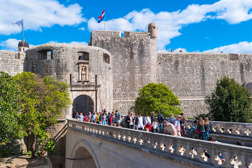 Pile Gate, Dubrovnik A line of people entering a walled city through a fortified stone gate tower