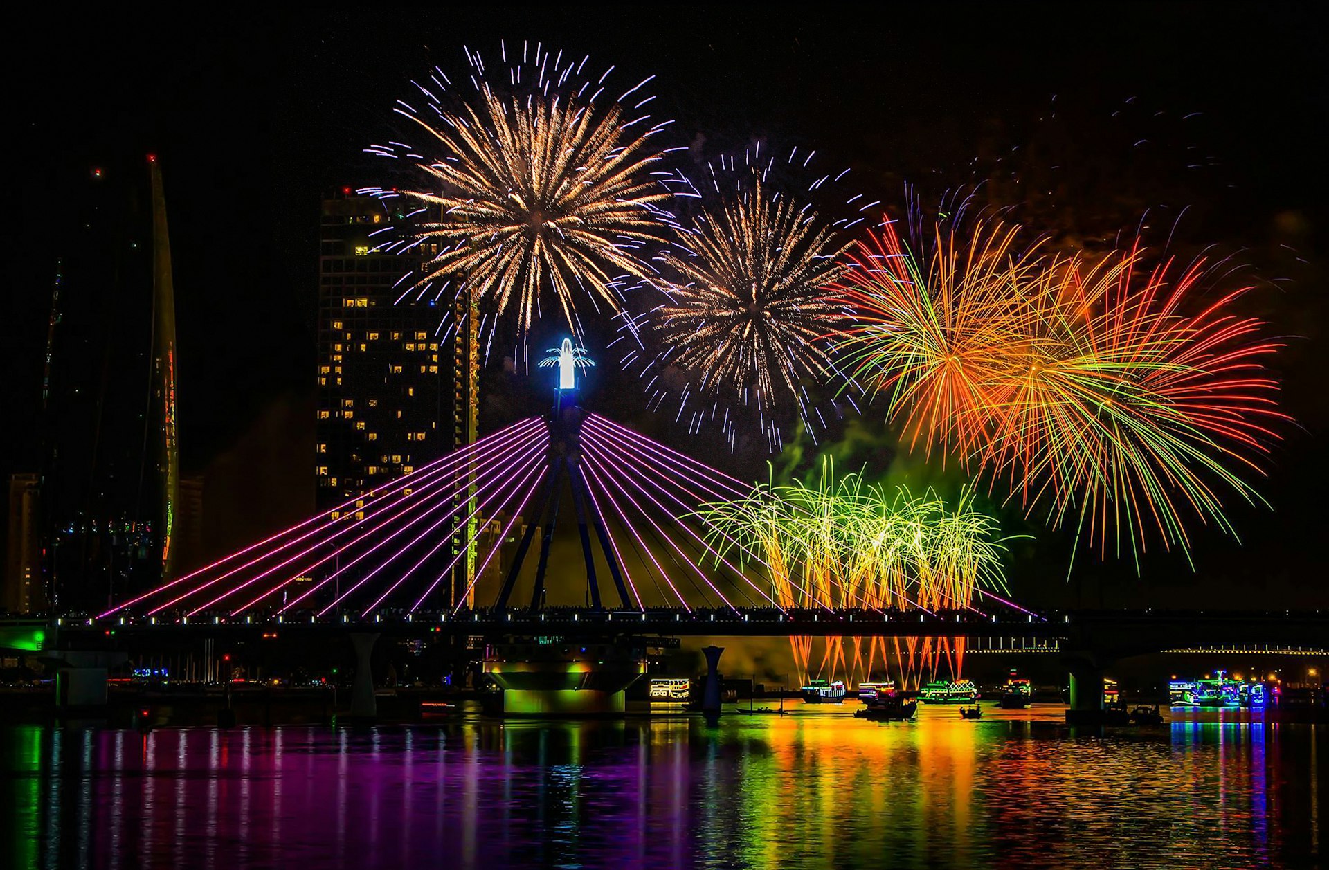 Colorful fireworks illuminate the night sky above the Han River in Danang, Vietnam.