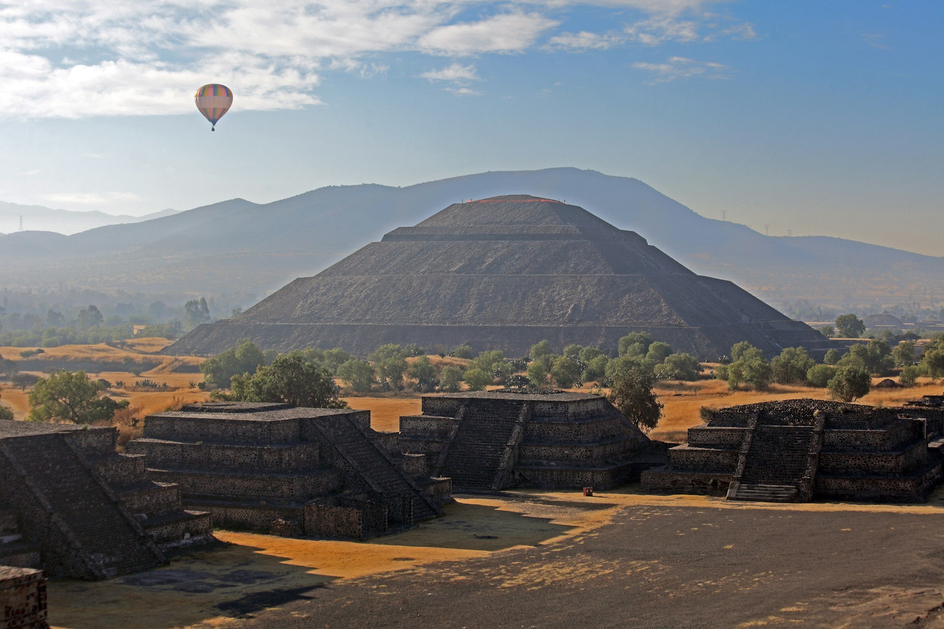 A hot-air balloon floats near the Pyramid of the Sun, as seen from the Pyramid of the Moon in Teotihuacán, Mexico
