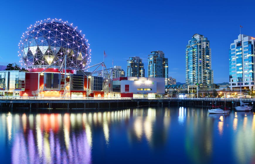 The geodesic dome of Vancouver's Science World lit up at night. 