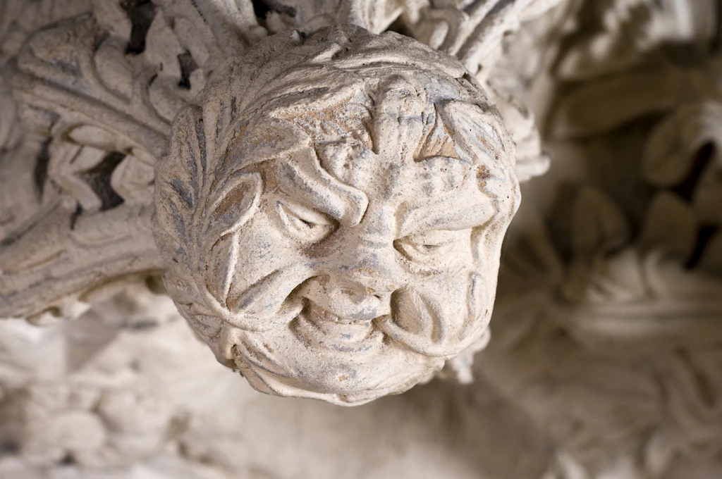 The Green Man carving, Rosslyn Chapel A stone carving of a male face coming out of a wall