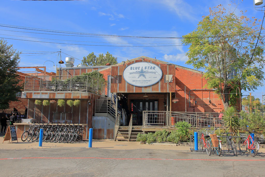 Blue Star Brewing Company, San Antonio A large warehouse-style building with lots of bikes on racks outside