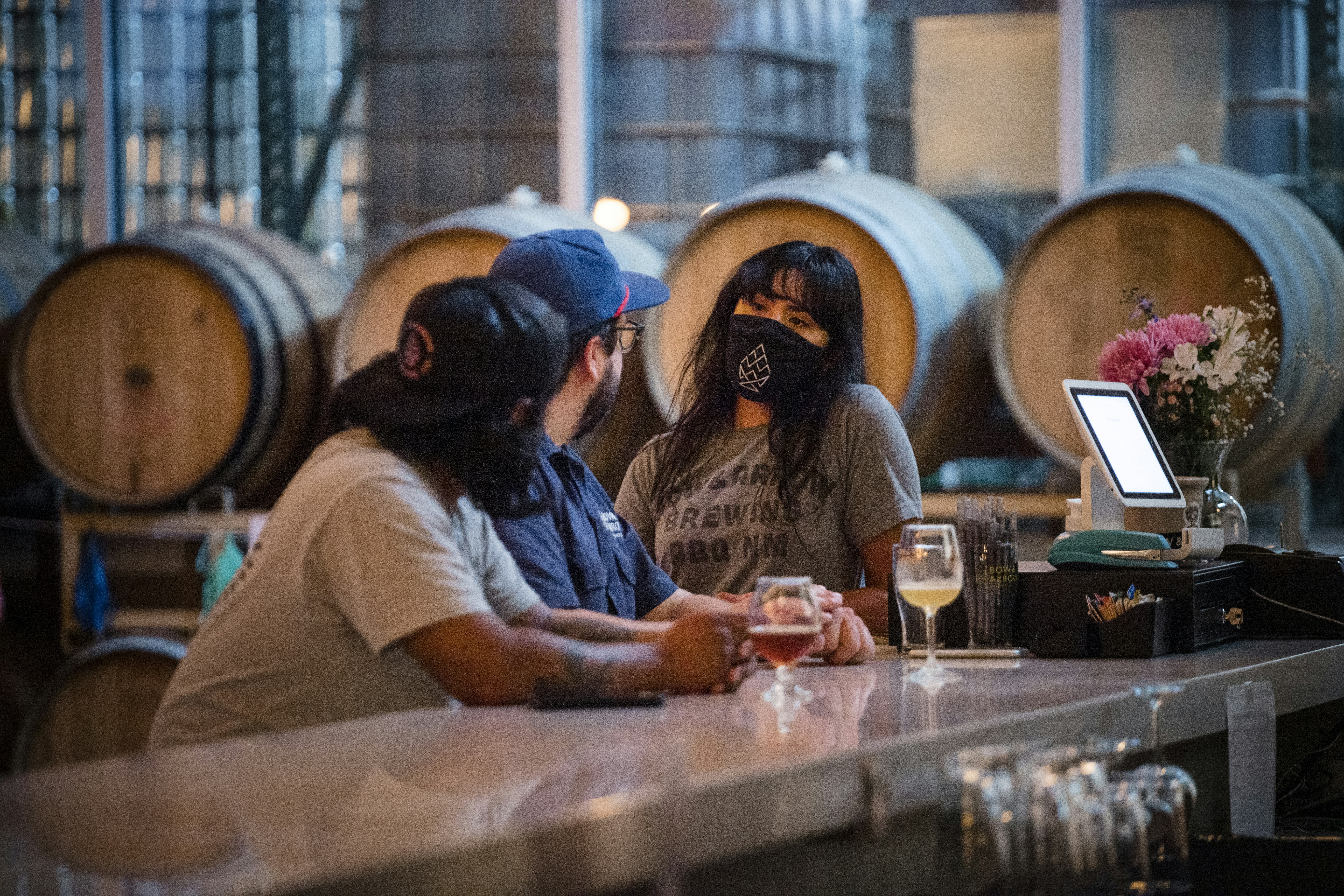 Bow and Arrow Brewing Co. founder and CEO Shyla Sheppard (R) talks to head brewer Ted O’Hanlan (C) inside the brewery on in Albuquerque, New Mexico.