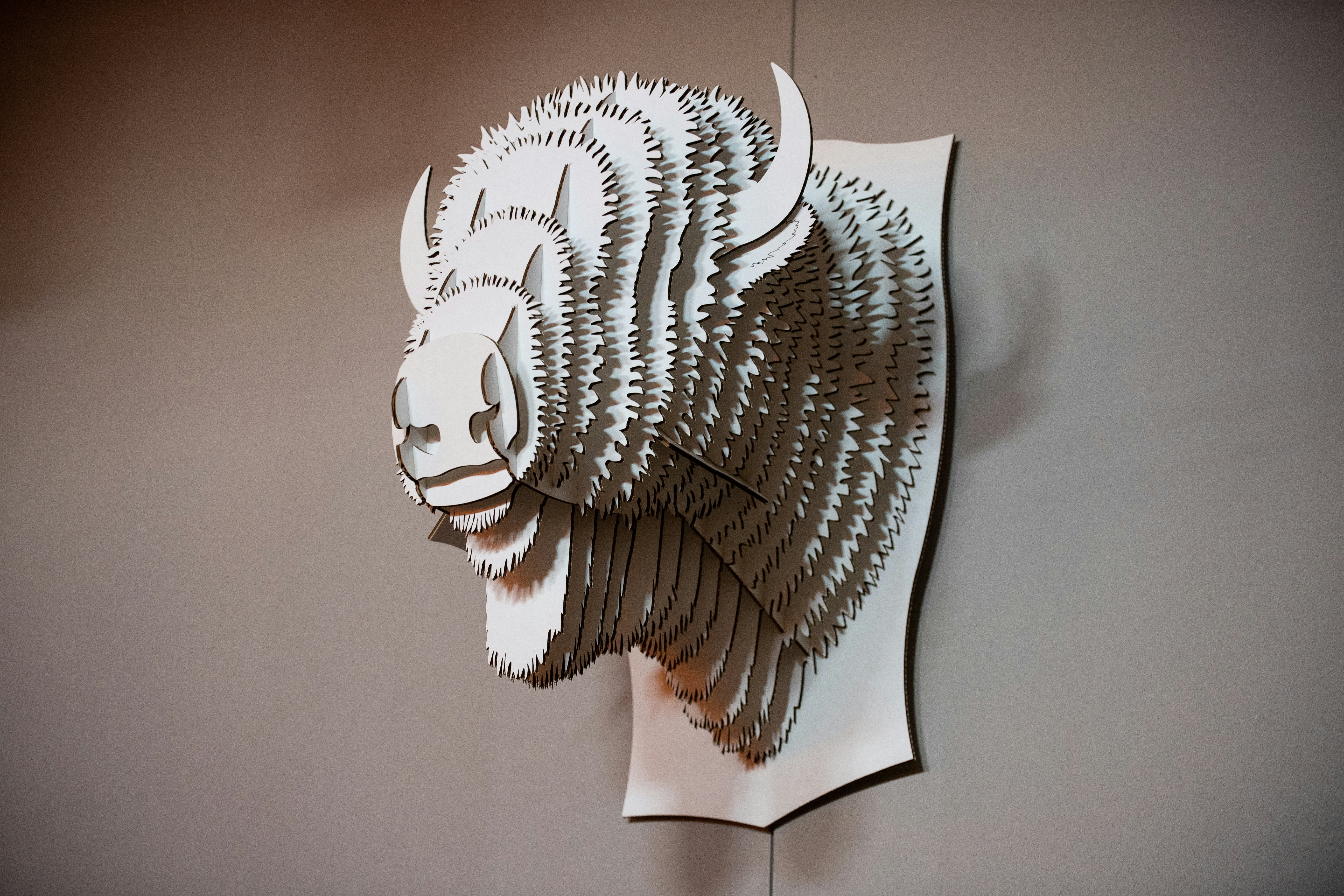A white card buffalo sculpture is displayed inside the Bow and Arrow Brewery in Albuquerque, New Mexico