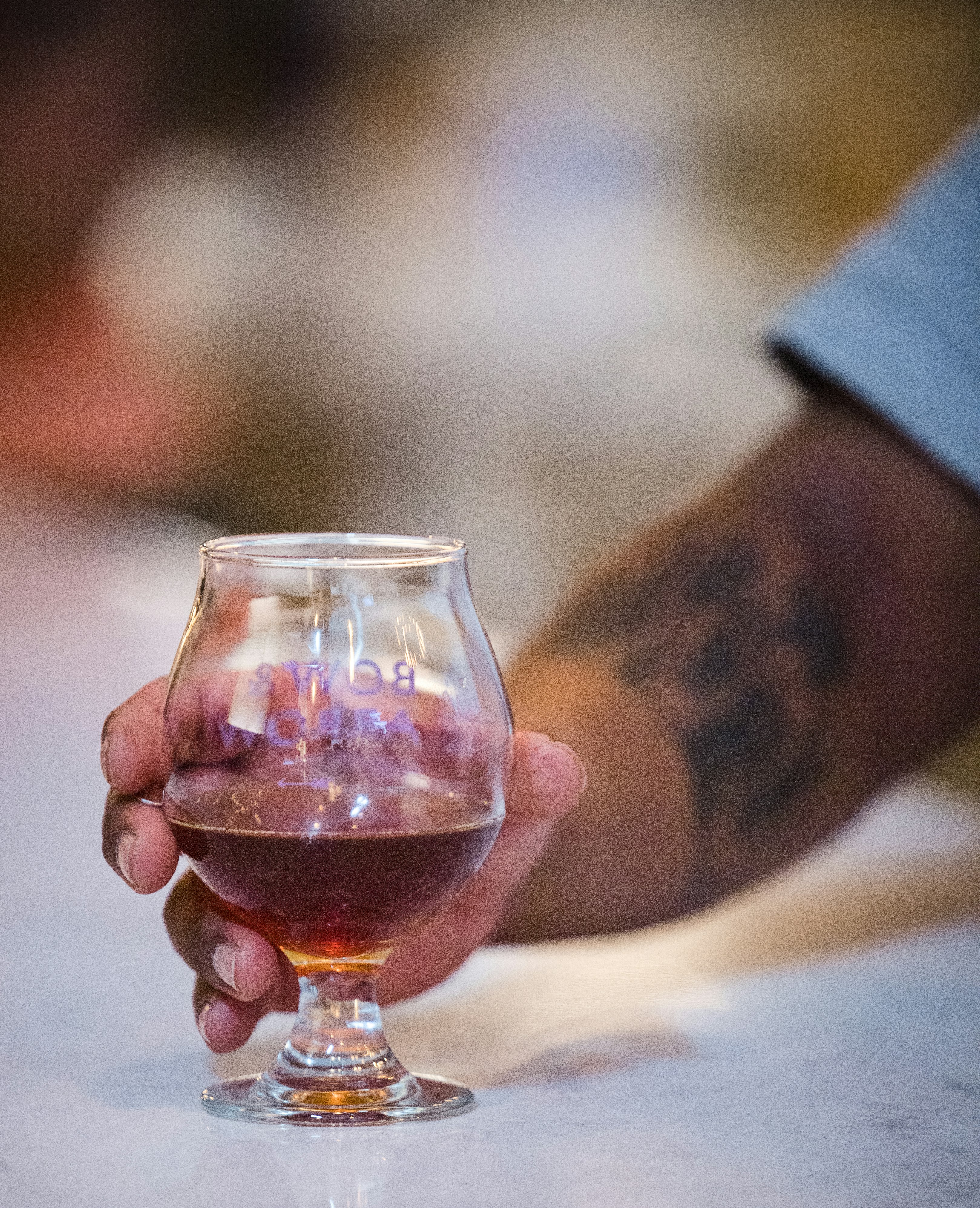 A customer holds a half-drunk beer at the Bow and Arrow Brewing Co. on July 14, 2021 in Albuquerque, New Mexico