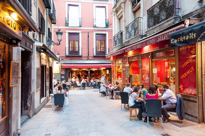 People seated at outdoor restaurants and bars in Huertas.