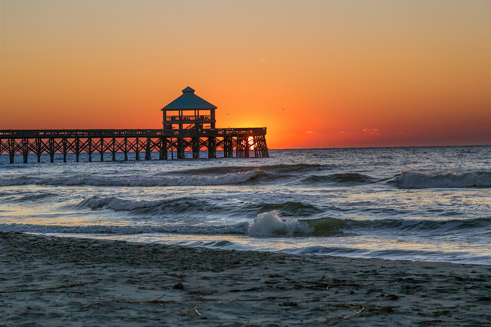 A beach pier at sunrise