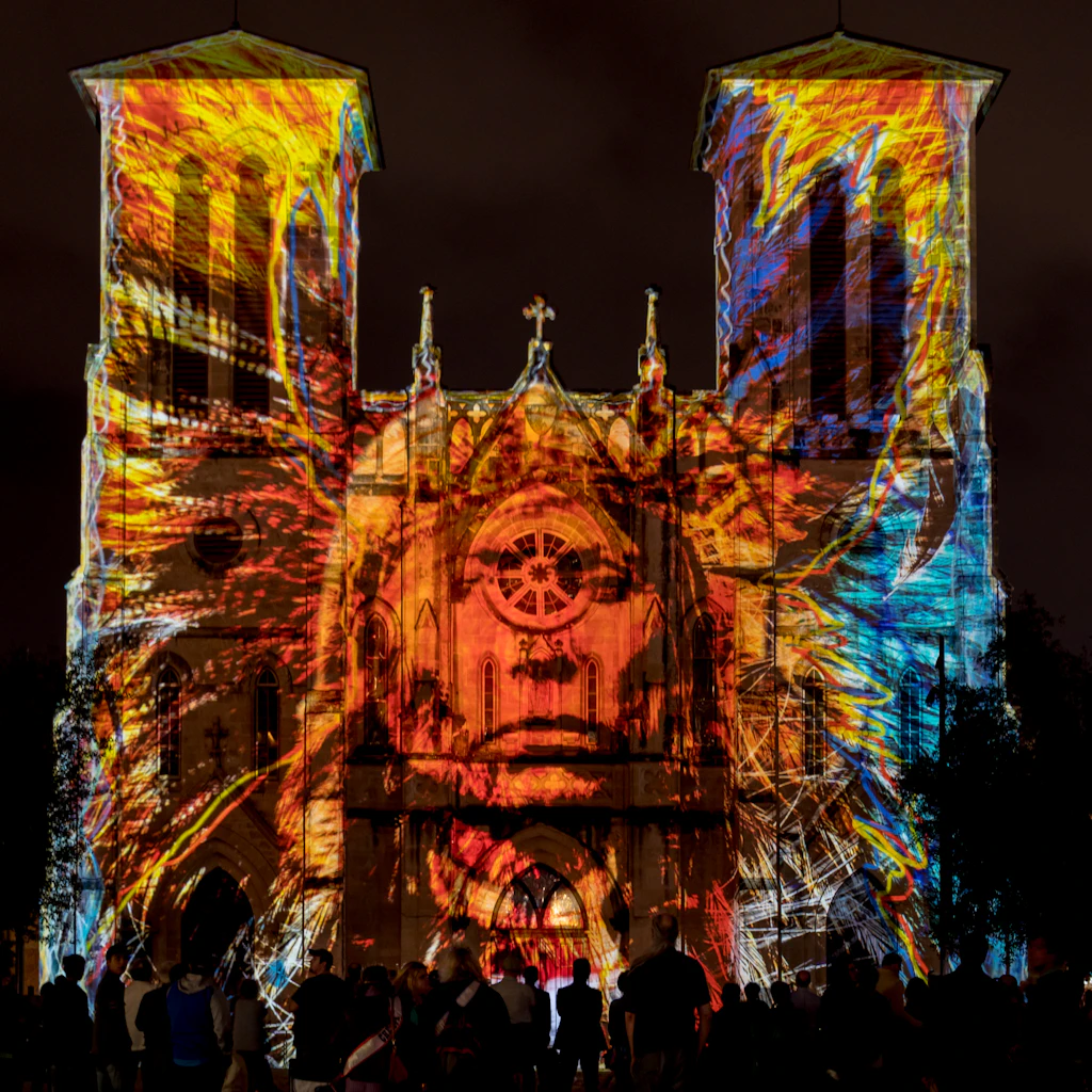 San Fernando Cathedral with Native American Light Show An image of a Native American projected onto the facade of a cathedral