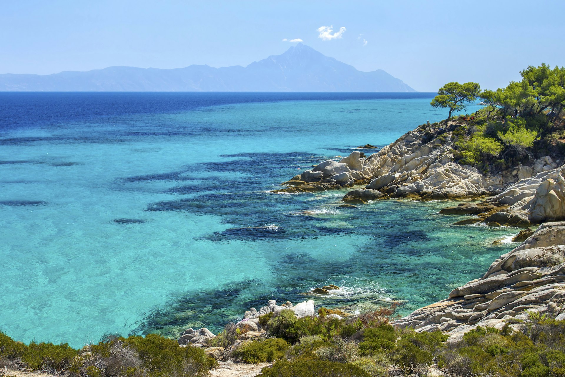 A rocky coastline and clear blue water on the Kassandra Peninsula of Halkidiki, Greece