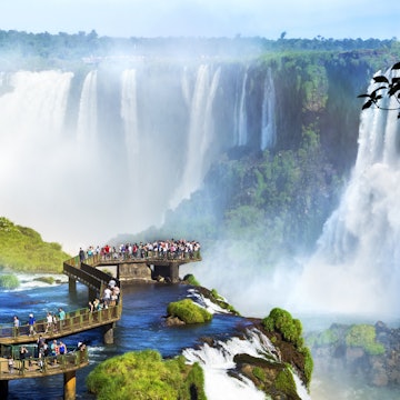 Tourists at Iguazu Falls, one of the world's great natural wonders, on the border of Brazil and Argentina.