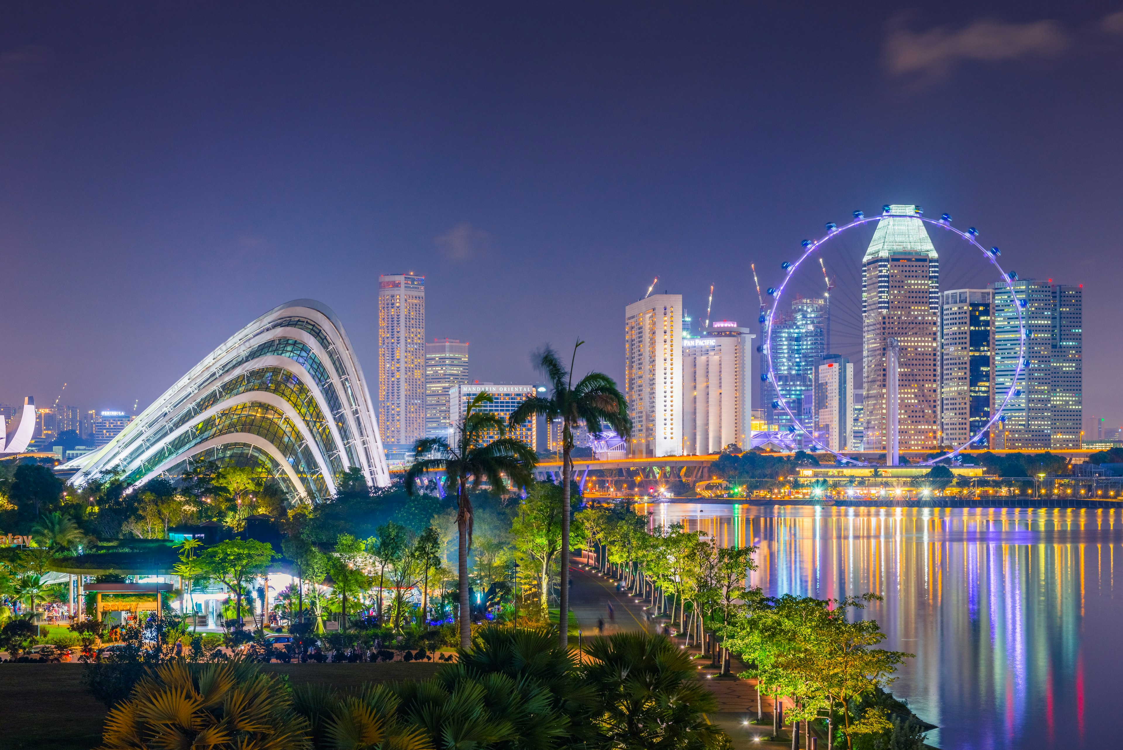 Two advanced architecture structures of Singapore, Flower Dome of Garden by the bay and famous Singapore flyer at night time show fabulous light and color, Singapore