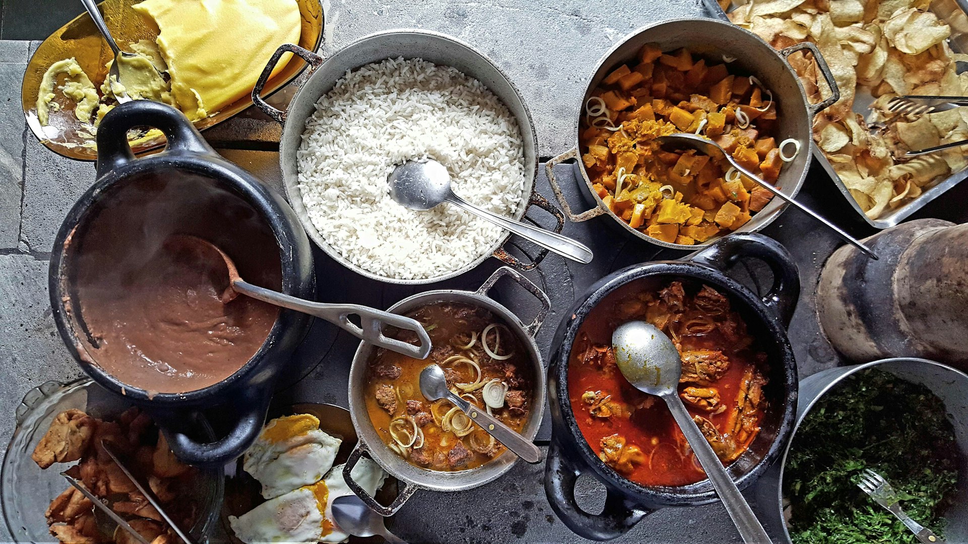 A variety of Indian dishes sitting on a wooden table