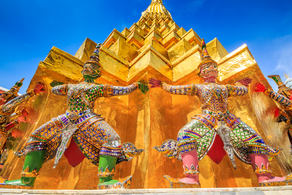Wat Phra Kaew guardians Statues of the yaksha, two brawny guardian giants from the Ramakian epic, greet visitors at Wat Phra Kaew.