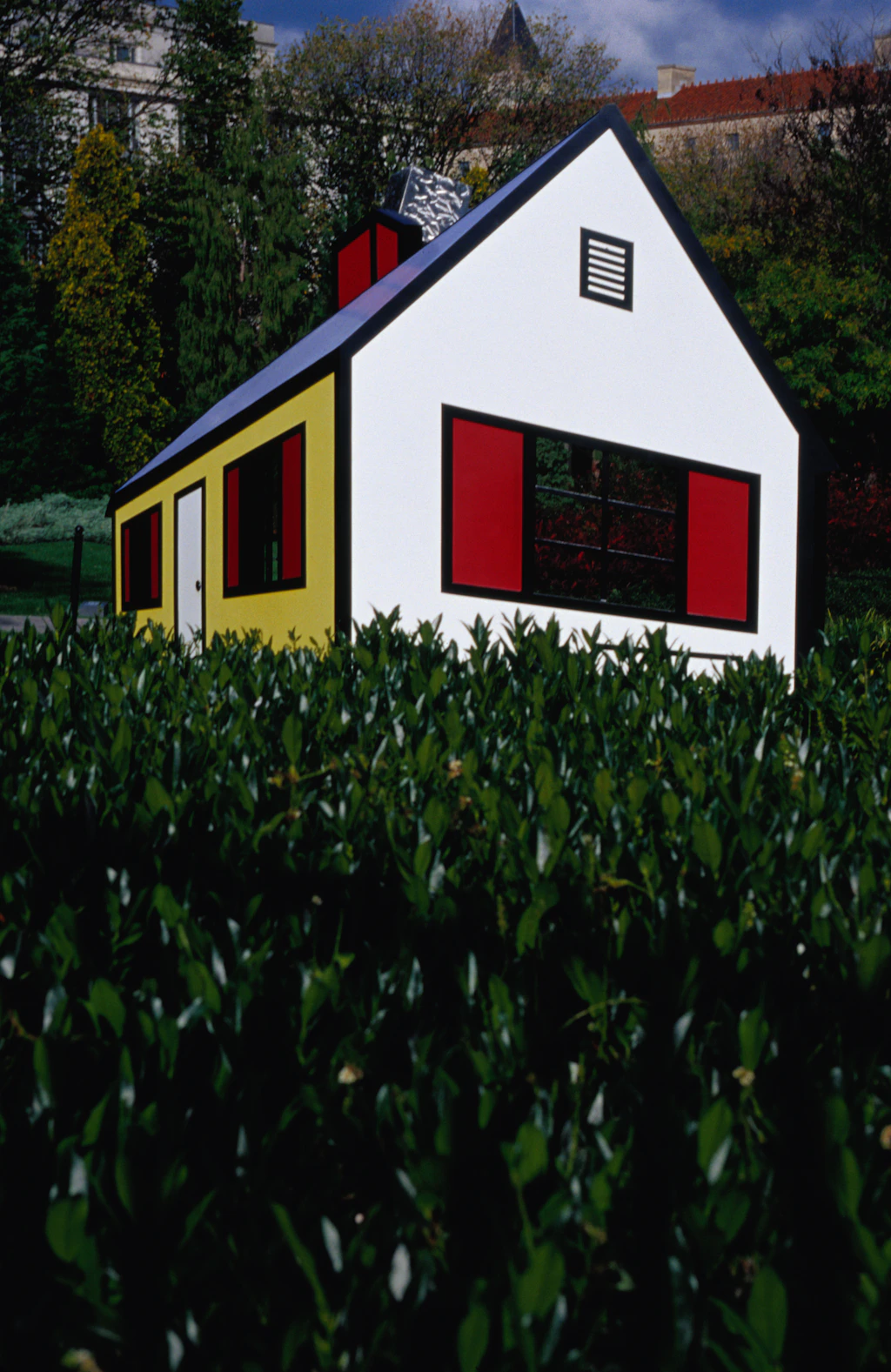 House I An artwork called House I by Roy Lichtenstein sits in the Sculpture Garden of the National Gallery of Art in Washington. Its brightly-colored sides in red and yellow stand out against the greenery of the gardens itself.