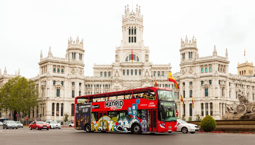 A bus drives past the front of Palace of Communication in Madrid, Spain