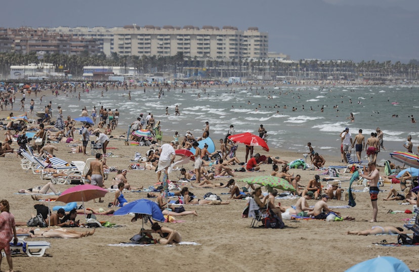 VALENCIA VALENCIAN COMMUNITY, SPAIN - JULY 12: The Malvarrosa Beach full of people on a day of red alert for high temperatures, on 12 July, 2021 in Valencia, Valencian Community, Spain. The provinces of Alicante, Valencia and Murcia have this Monday warnings of red level (extreme risk) for maximum temperatures, according to the forecast of the State Meteorological Agency (AEMET). According to the Agency, temperatures will continue to rise throughout the day in the Mediterranean area, a rise that will be noticeable in the south of the Levant. (Photo By Rober Solsona/Europa Press via Getty Images)