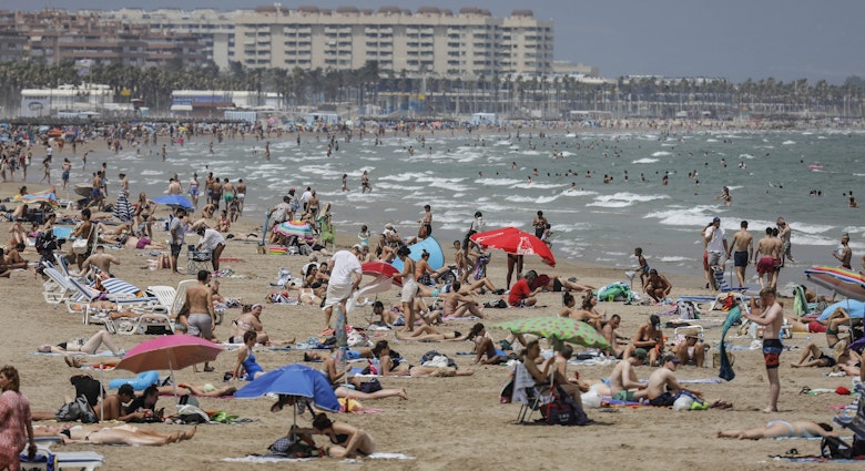 VALENCIA VALENCIAN COMMUNITY, SPAIN - JULY 12: The Malvarrosa Beach full of people on a day of red alert for high temperatures, on 12 July, 2021 in Valencia, Valencian Community, Spain. The provinces of Alicante, Valencia and Murcia have this Monday warnings of red level (extreme risk) for maximum temperatures, according to the forecast of the State Meteorological Agency (AEMET). According to the Agency, temperatures will continue to rise throughout the day in the Mediterranean area, a rise that will be noticeable in the south of the Levant. (Photo By Rober Solsona/Europa Press via Getty Images)