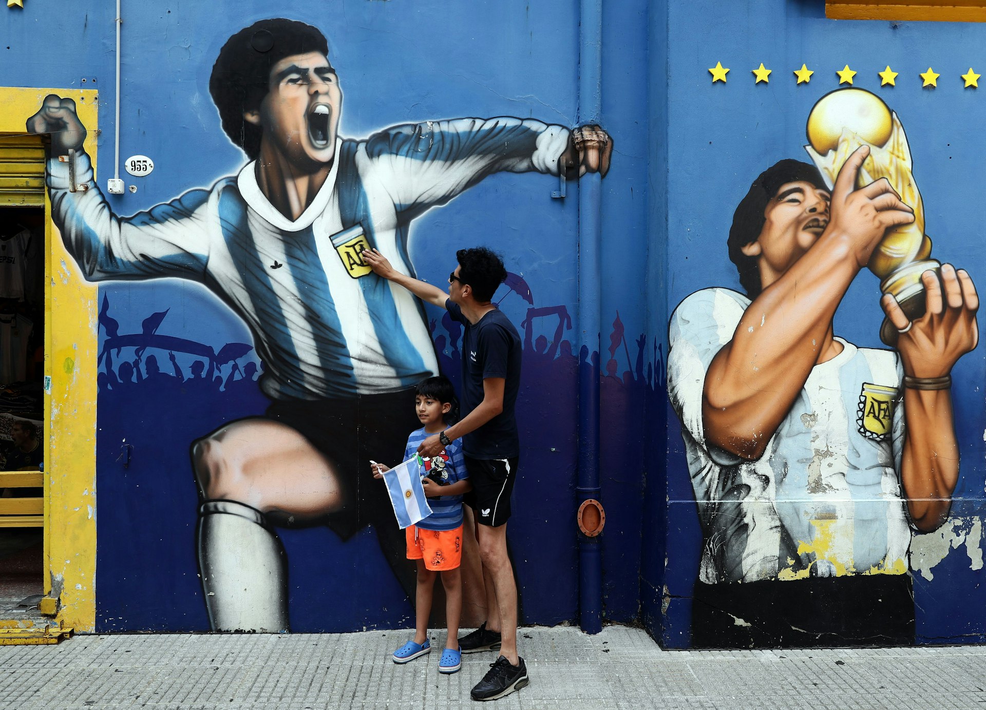 Fans pay tribute at a soccer mural in La Boca, Buenos Aires