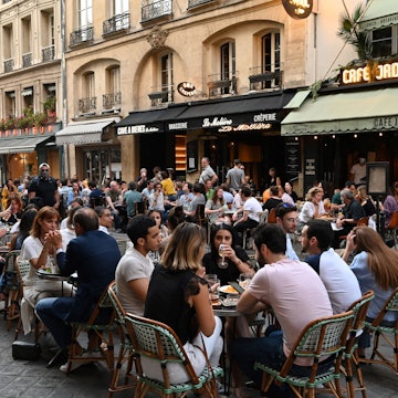 People eat and have drinks on restaurant and cafe terraces in the rue de Buci in Paris on June 2, 2020, as cafes and restaurants reopen in France with the easing of lockdown mesures taken to curb the spread of the COVID-19 pandemic, caused by the novel coronavirus. - French cafes and restaurants reopened their doors on June 2 as the country took its latest step out of coronavirus lockdown, with clients seizing the chance to bask on sunny terraces after 10 weeks of closures to fight the outbreak. (Photo by BERTRAND GUAY / AFP) (Photo by BERTRAND GUAY/AFP via Getty Images)