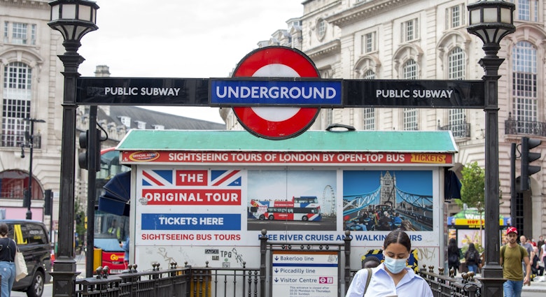 LONDON, UNITED KINGDOM - 2021/07/13: A woman leaves Piccadilly Circus underground station wearing a face mask..The mandatory wearing of Face masks on public transport in England is to end on the 19th July dubber freedom day after Boris Johnson confirmed that most mandatory Covid-19 restrictions will end. (Photo by Dave Rushen/SOPA Images/LightRocket via Getty Images)