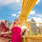 A beautiful 17 year old girl with pink hair enjoying a rare sunny day on the Roberto Clemente Bridge in downtown Pittsburgh, PA, USA.